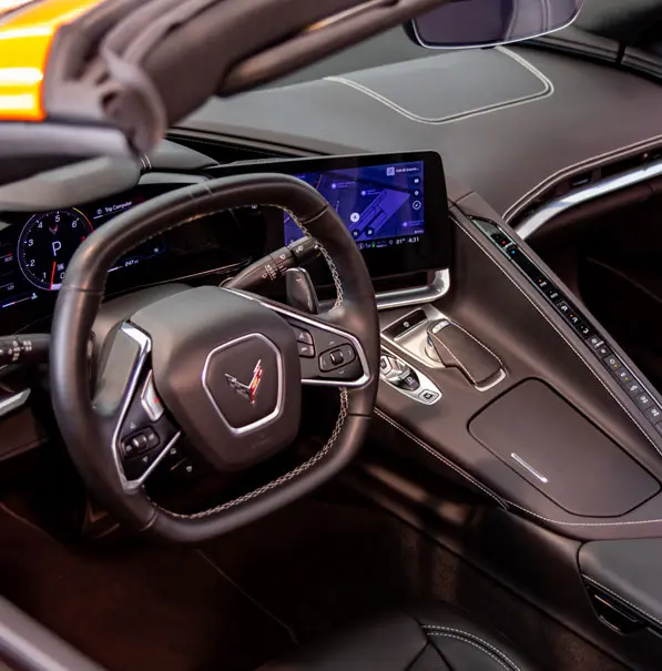 Steering wheel and dashboard in interior of luxury car.